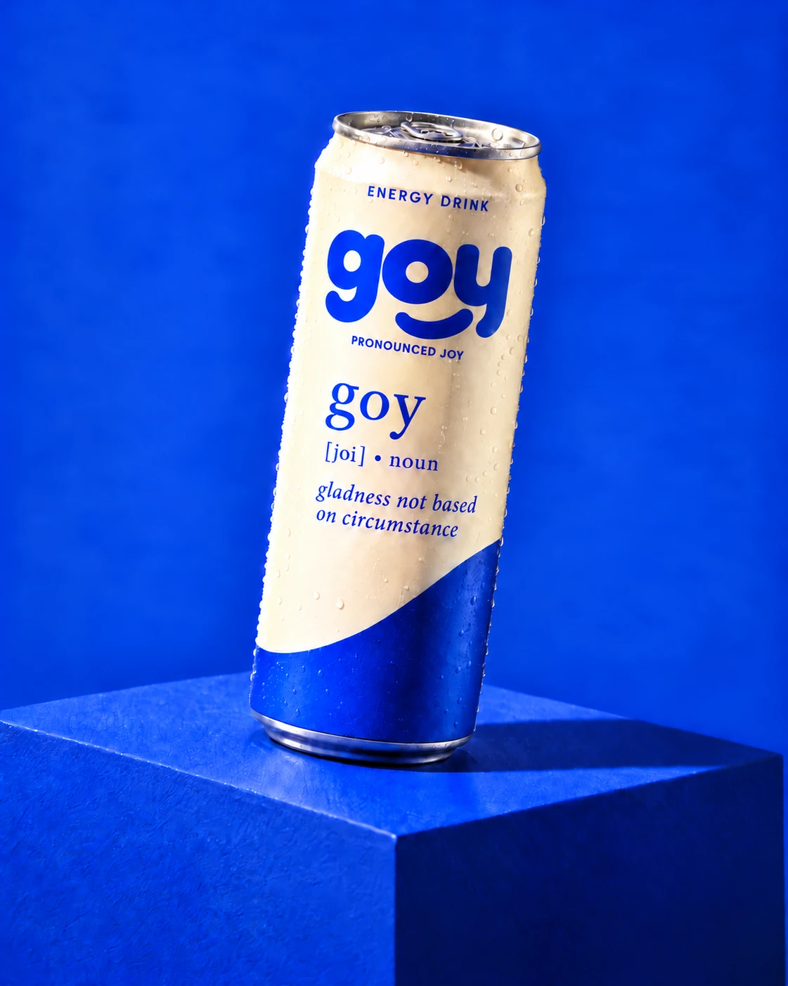 GOY can on a rich-blue pedestal with the Joy definition printed on the front